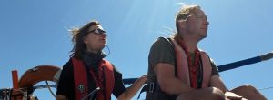 RYA Sailing Courses - Two sailors feel the sun on their faces and the wind in their hair
